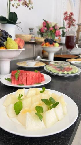 a table topped with plates of food on a counter at Hotel Caravan Serail in Samarkand