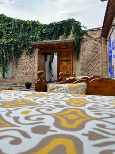 a bedroom with two beds with a pattern on a bedsheet at Hotel Caravan Serail in Samarkand