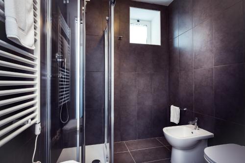 a bathroom with a shower and a toilet and a sink at Residence Peloni in Arezzo