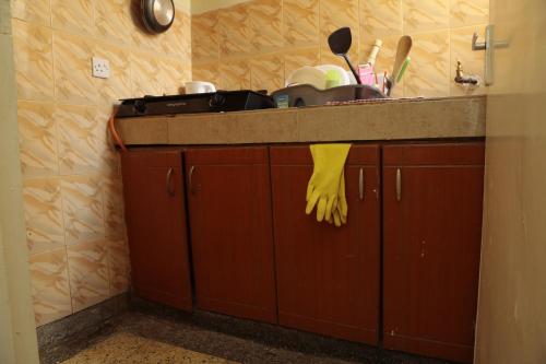 a kitchen counter with a sink and some dishes at Rooftop Haven Allsoaps in Nairobi