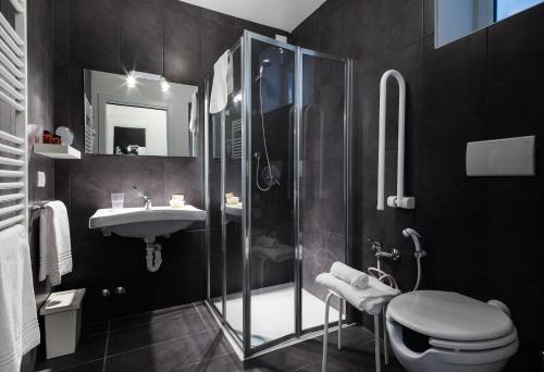 a bathroom with a shower and a toilet and a sink at Residence Peloni in Arezzo