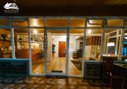 a room with sliding glass doors and a living room at Mirador Old-Time House walking distance to Lourdes Grotto in Baguio