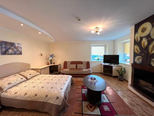 a bedroom with a bed and a living room at Nakvisa in Zarasai
