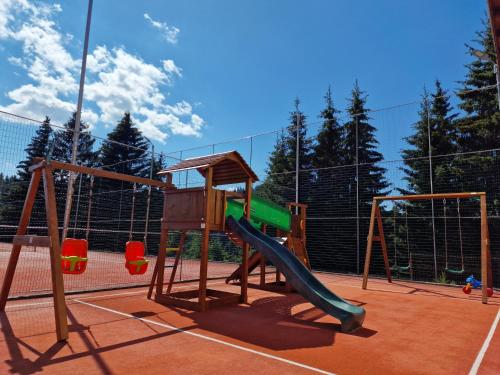 a playground with a slide on a tennis court at Resort EuroPark Fundata in Fundata