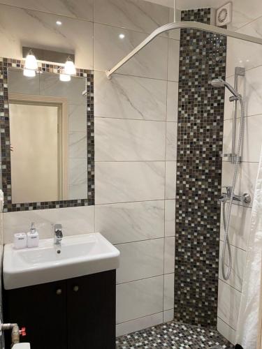 a bathroom with a sink and a shower at Vilnius City Walls apartment in Vilnius
