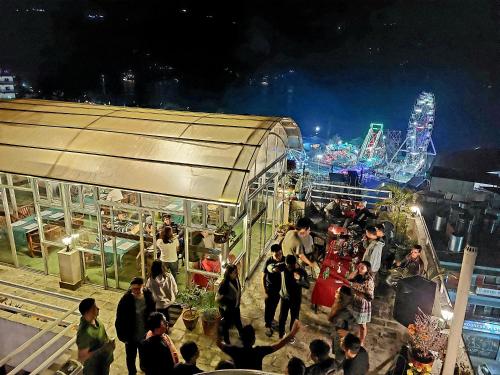 a group of people standing outside of a building at night at Hotel Kunja in Pokhara