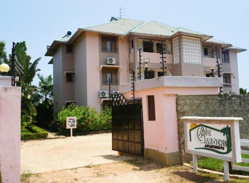 a house with a gate in front of it at Galu Gardens Diani Beach ,Coastal Apartments by Nest & Nomad in Kwale