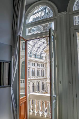 a window with a view of the palace ofminster at Maison San Carlo Luxury Suites in Naples