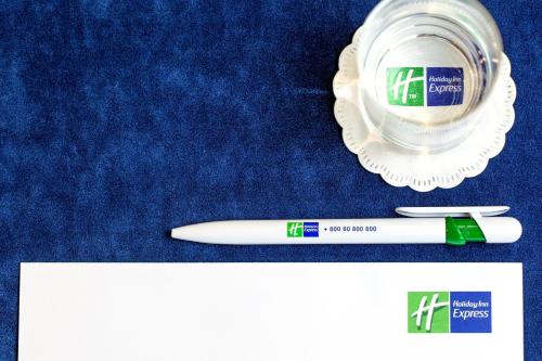 a toothbrush and a tube of toothpaste next to a tooth paste at Holiday Inn Express Lisbon-Oeiras by IHG in Oeiras