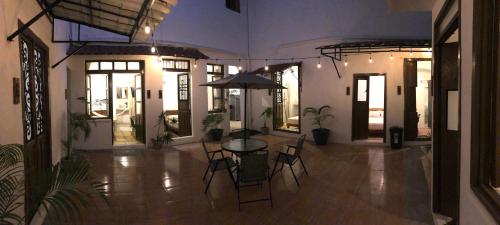 a room with a table with chairs and an umbrella at Bleu Downtown in Campeche