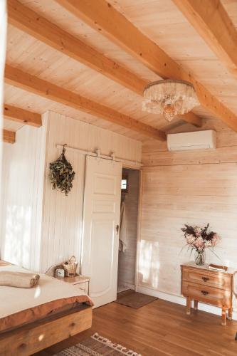 a bedroom with a bed and a wooden ceiling at Ambercoast in Jūrmala