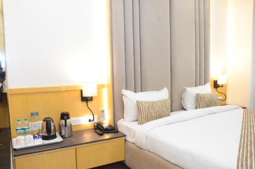 a hotel room with a bed and a coffee maker at CRYTSAL RESIDENCY in Rānchī