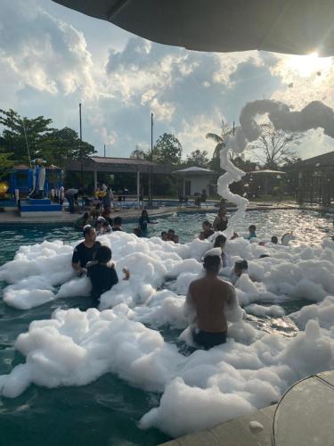 a group of people in foam bubbles in a swimming pool at Dna Fun Zone Pekanbaru in Pekanbaru