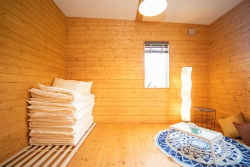 a room with a stack of towels on a table at Awaji Seaview Resort in Nojimakifune in Kusumoto