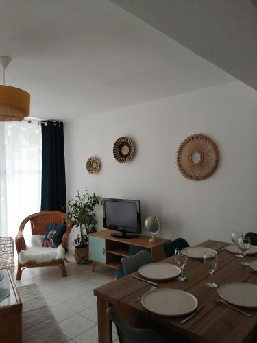 un salon avec une table et une télévision dans l'établissement Apptt rénové bien situé parking terrasse vélos, à Blois
