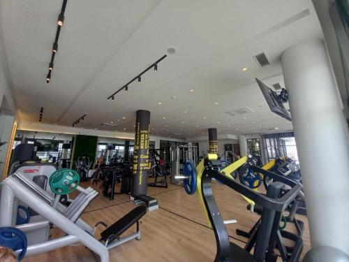 a gym with several cardio machines in a room at Apartment Long Beach in Saint Yeorgios