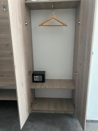 a room with a shelf with a clock on it at Hotel Maya in Horezu