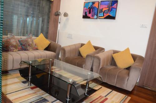 a living room with two couches and a coffee table at CRYTSAL RESIDENCY in Rānchī