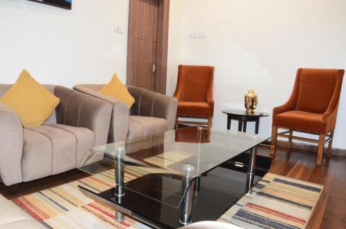a living room with a couch and two chairs at CRYTSAL RESIDENCY in Rānchī