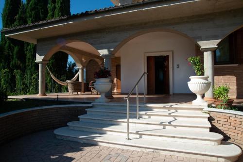 a porch with stairs and vases on a house at La Villa dei Tartufi - B&B in Corfinio