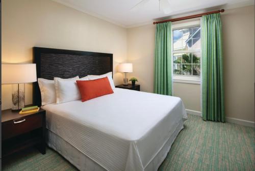 a hotel room with a large bed and a window at Harbourside Resort, Paradise Island Bahamas in Nassau