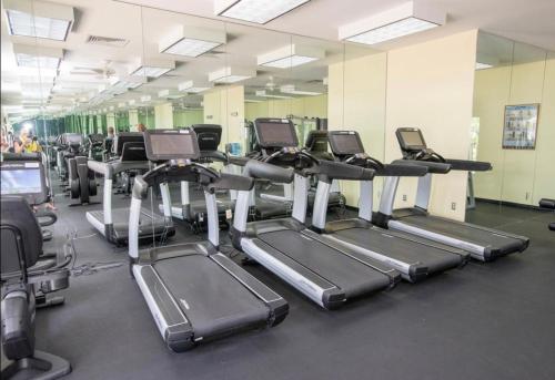a gym with rows of tread machines in a room at Harbourside Resort, Paradise Island Bahamas in Nassau