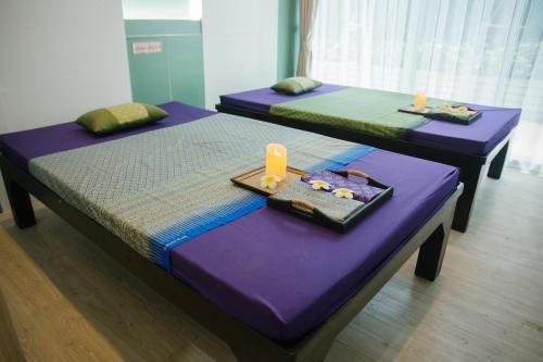 three beds in a room with a tray of food at D Eco Wellness Center in North Pattaya