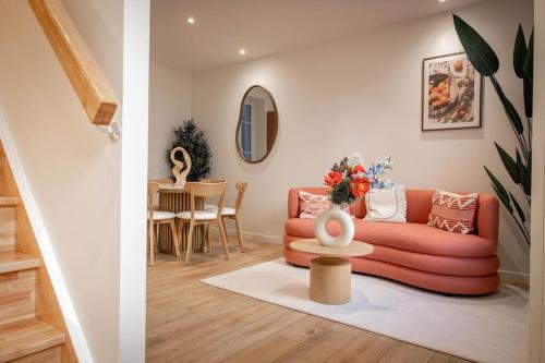 a living room with a couch and a table at Villa La Roseraie in Vichy