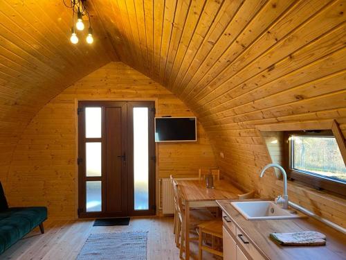 a kitchen with a large wooden ceiling with a door at Luxurious Livada Bungalow 