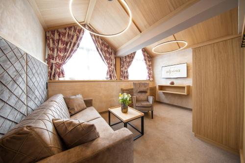 a living room with a couch and a table at Hotel Alpina deluxe in Obergurgl