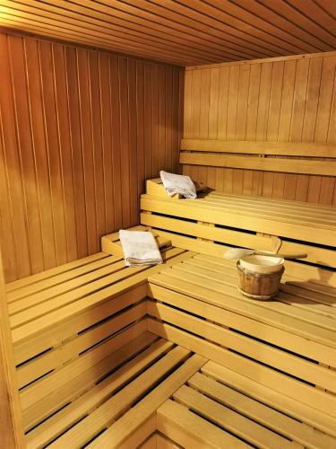 an empty wooden sauna with a wooden tub at Hotel la Plaza in Corvara in Badia