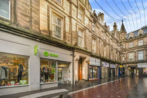 an empty street in a city with buildings at Lombard Hide Away in Inverness