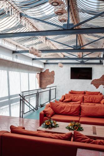 a living room with red couches in a building at Villa Cesi Resort & Spa in Impruneta