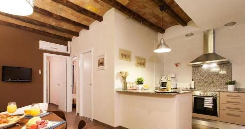 a kitchen with a table and a counter top at Apartament modern al carrer Blai, Poble Sec in Barcelona