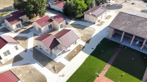 an overhead view of a row of houses with a pool at Incanto Glamping village in Savio di Ravenna