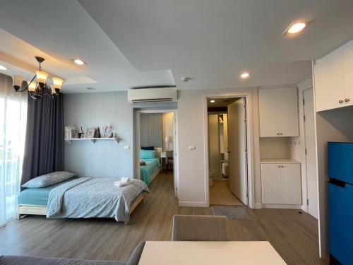 a bedroom with a bed and a living room at The Blu X Condo Bangsean R9 in Ban Bang Saen (1)