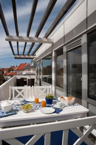 a table with plates of food on a balcony at Lichtdurchflutete Ferienwohnung mit Südbalkon in Wangerooge