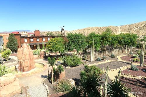 a garden with trees and plants in front of a building at Centro Vacacional Macenas in Mojácar