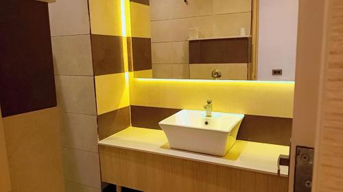 a bathroom with a sink and a mirror at Hotel King's way in Amritsar