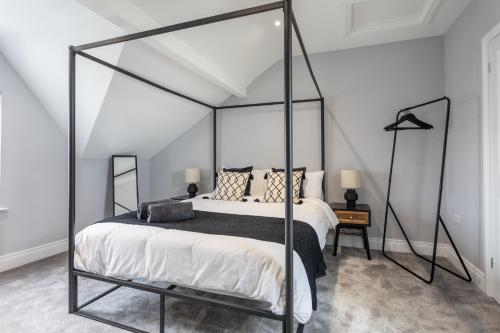 a bedroom with a black and white canopy bed at Luxury Edwardian Townhouse in Belfast in Belfast
