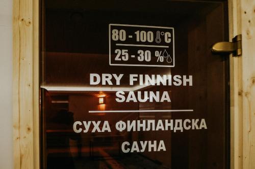a sign on the door of a shop at Hotel Green Park Service Perfected in Garmen