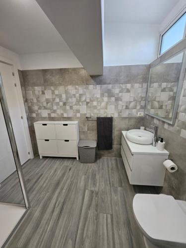 a bathroom with a white toilet and a sink at Chalet Luxury with privacy and Jacuzzi in Maspalomas