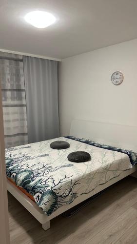 a bed with two pillows on it in a bedroom at Beautiful apartment Lena in Split