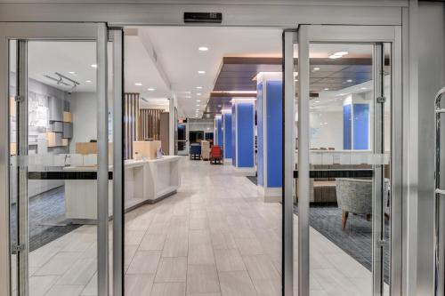 a lobby with sliding glass doors in a building at Holiday Inn Express - Fort Walton Beach Central by IHG in Fort Walton Beach