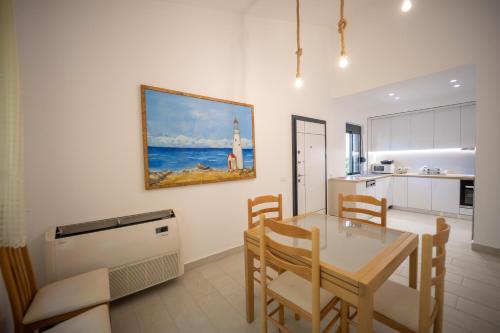 a kitchen and dining room with a table and chairs at "Blue Bay Villa" at Gjiri Lalzit, Lalzi Bay, Lura 1 in Durrës
