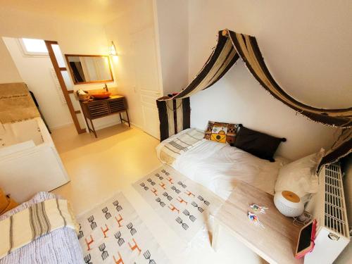 a bedroom with a bed with a canopy at Dream of Mediterranean house, Jacuzzi, BBQ, Délices ensoleillés in Sartrouville