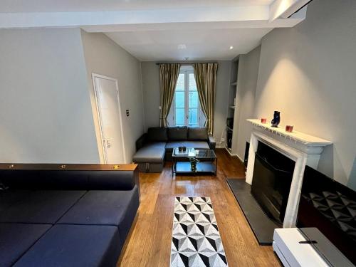 a living room with a couch and a fireplace at 4 floor Apartment in Covent Garden in London