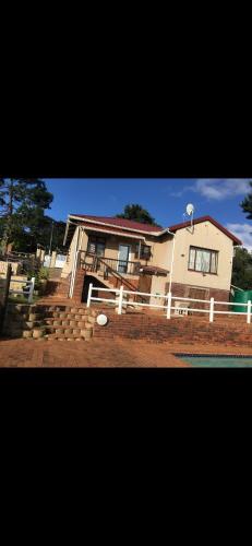 une maison avec une clôture devant elle dans l'établissement 3 Bedroom Manor Gardens House, à Durban
