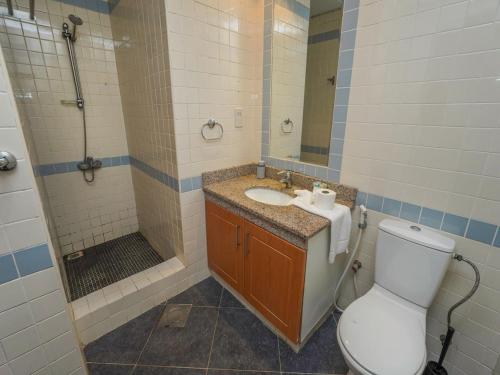 a bathroom with a toilet and a sink and a shower at 2 BHK @ Barsha Heights in Dubai