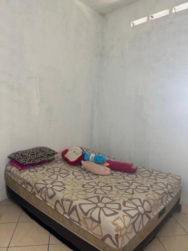 a bed in a room with two dolls on it at Holiday Park 